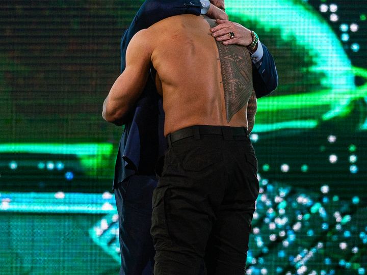 Roman Reigns and Paul Heyman embracing at WrestleMania XL