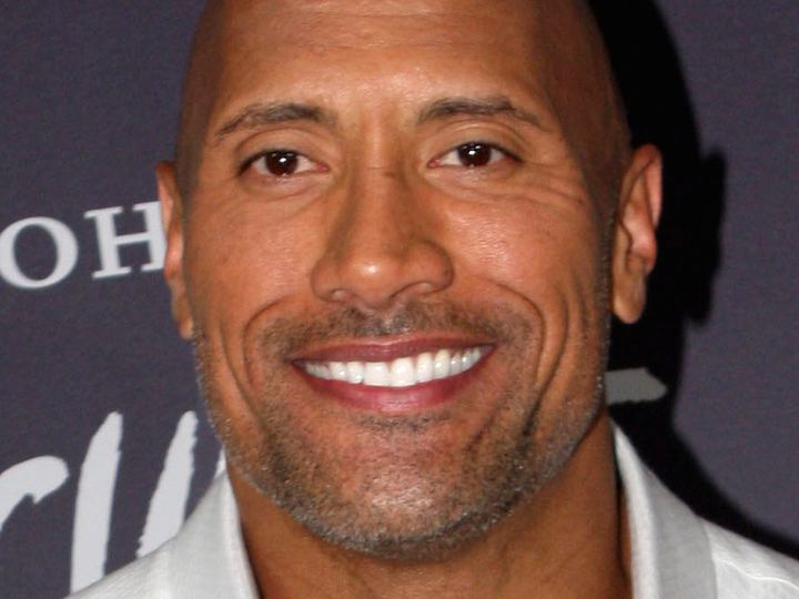 Dwayne Johnson smiling at a film premiere in Sydney in 2014