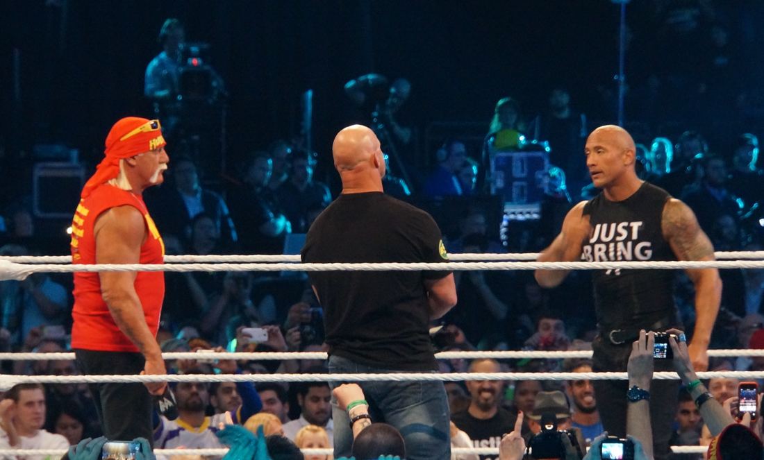 Hulk Hogan, Stone Cold Steve Austin and The Rock standing together in the ring at WrestleMania XXX
